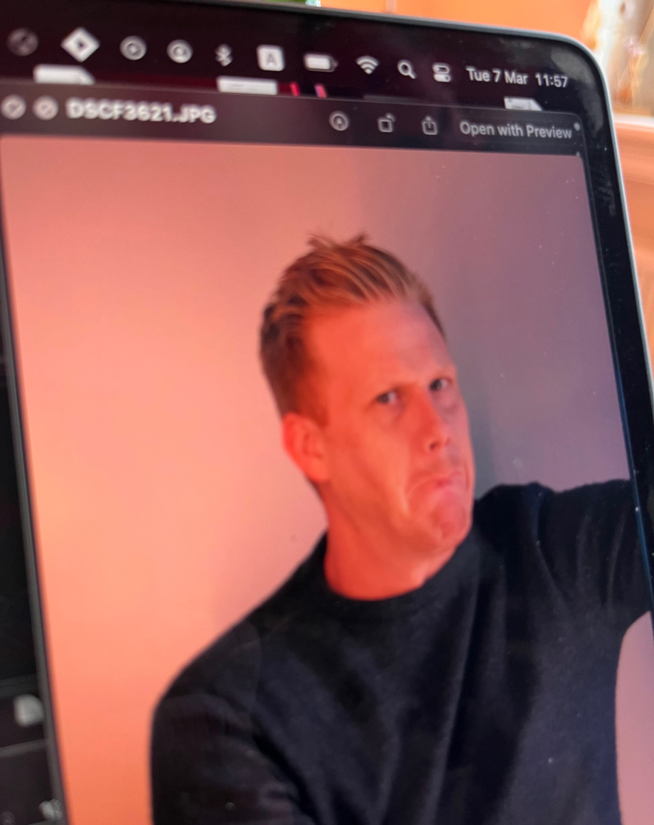 a laptop with a person on the screen looking funny