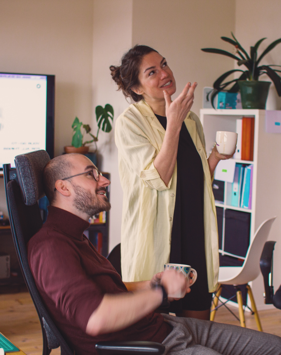 Two colleagues staring at something in the office and pointing at it