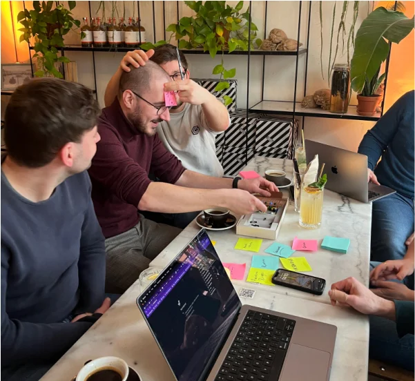 Colleagues in a bar playing who am I